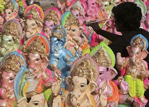 An artisan paints a statue of Ganesha on a roadside in the western Indian city of Ahmedabad.