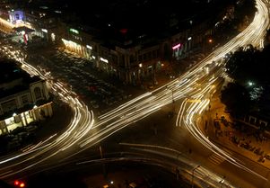 Traffic moves at busy intersection in New Delhi