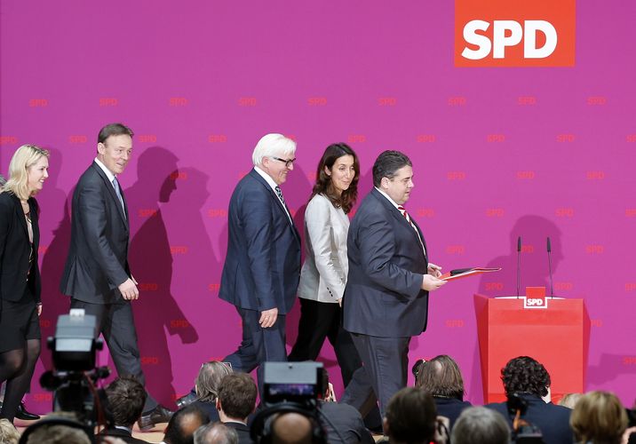 Leader of the Social Democratic Party (SPD) Sigmar Gabriel (R) arrives for a news conference in Berlin