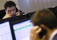 A Hungarian currency trader makes a phone call at his desk in Budapest 