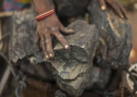 A local woman prepares to carry coal at an open coal field at Dhanbad district in the eastern Indian state of Jharkhand September 19, 2012. 