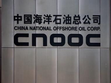 A logo is seen on the wall at the entrance of China National Offshore Oil Corp (CNOOC) office tower in Beijing