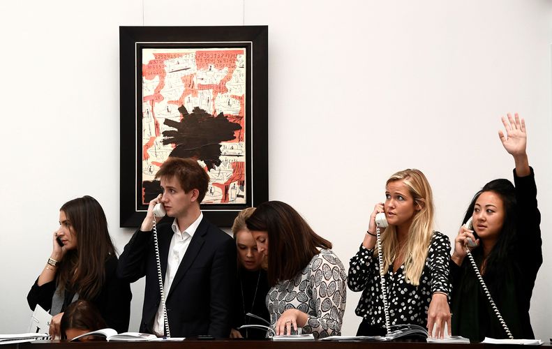 Employees take telephone bids during an auction at Sotheby's