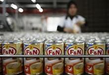 A worker prepares to pack Fraser and Neave condensed milk at its factory outside Kuala Lumpur