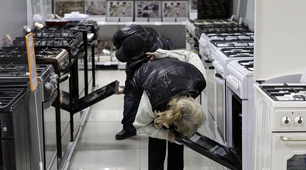 Customers inspect kitchen stoves at an electronic store in Stavropol, southern Russia