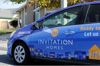 A car from Invitation Homes is shown parked outside a rental home 