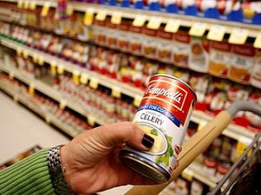 A customer holds a can of cream of celery Campbell's Soup at a grocery store in Phoenix, Arizona