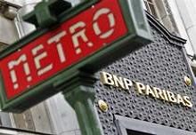The Paris headquarters of the BNP Paribas bank is seen near a Paris Metro sign 