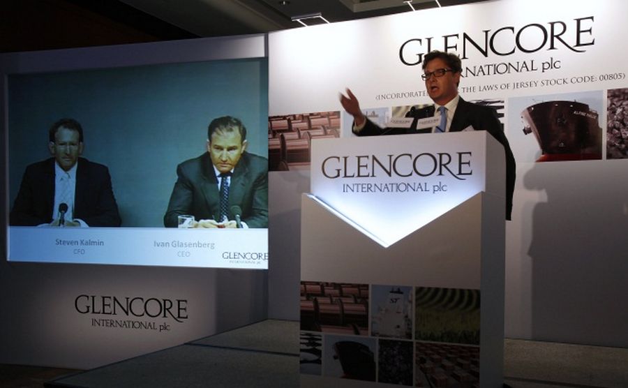 Glencore CEO Ivan Glasenberg and CFO Steven Kalmin are broadcast on a screen during a tele-conference