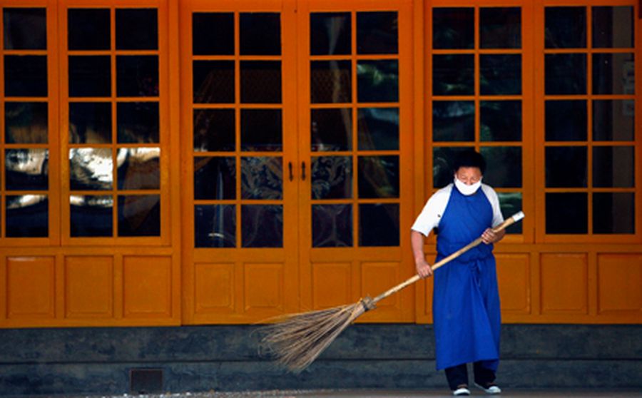 A man sweeps the floor at a Buddhist temple in Dharamsala 
