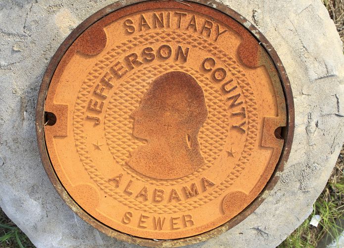 A manhole cover bears the logo/design of Jefferson County, Alabama