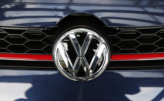 A VW emblem is pictured on a Volkswagen car in a delivery tower at the plant of German carmaker in Wolfsburg