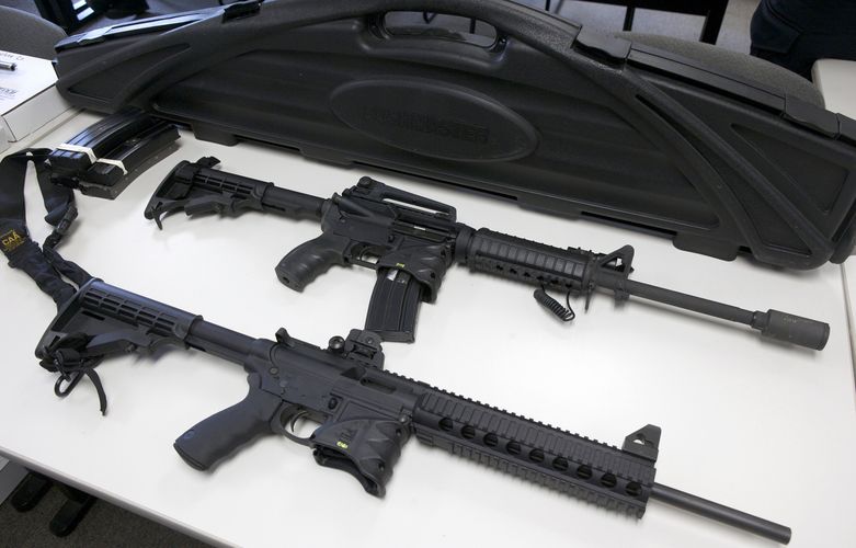 A Bushmaster semi-automatic assault rifle (top) and a Smith & Wesson semi-automatic rifle