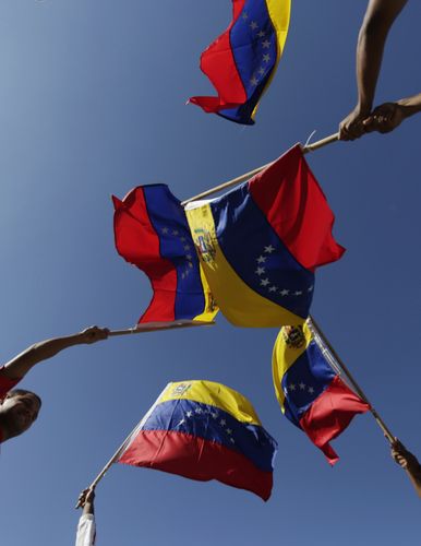 People hold Venezuela national flags