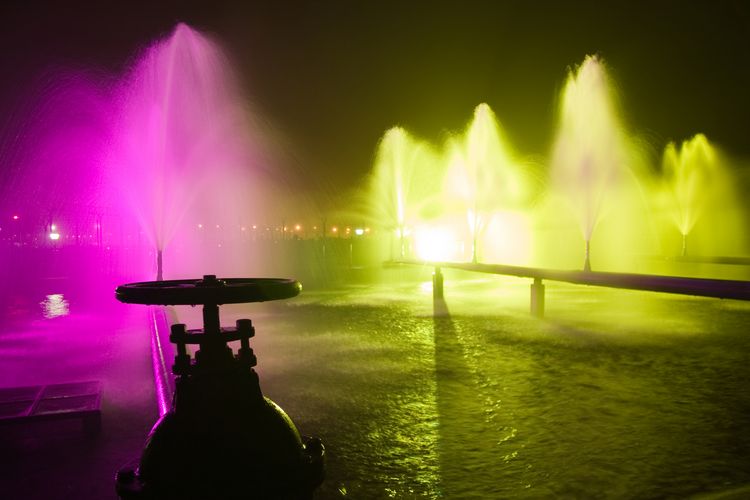 Colourful industrial fountains at night