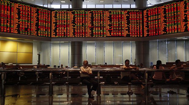 Investors monitor stock market prices in Kuala Lumpur 
