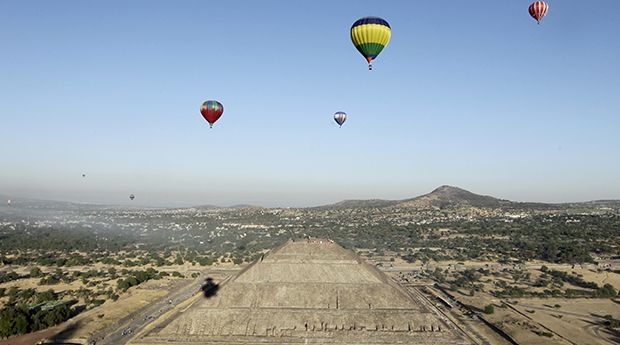 Hot air balloons float above the Pyramid of the Sun of Teotihuacan outside Mexico City