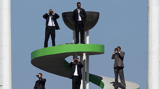 Security guards use binoculars to keep watch during the Algeria Cup final soccer match between CR Belcourt and Entente Setif in Algiers
