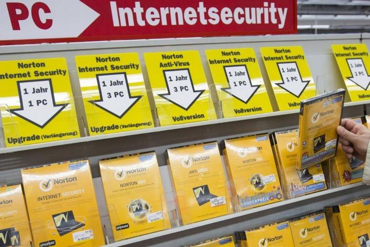  A man takes a box of internet security software from a shelf at an electronic retailer in Berlin, July 11, 2013. 