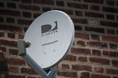 A DirecTV dish is seen outside a home in the Queens borough of New York