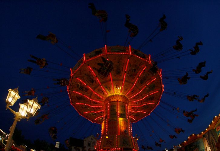 Visitors ride the chairoplane during the Duerkheimer Wurstmarkt in the southwestern German town of B
