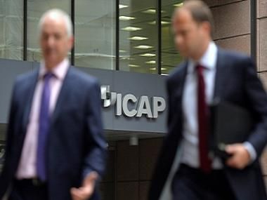 People walk past an ICAP office in the City of London