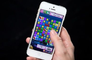A woman plays Candy Crush on her iPhone in New York