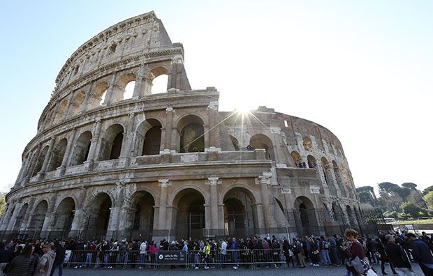 People stand in queue at the entrance of Rome's ancient Colosseum