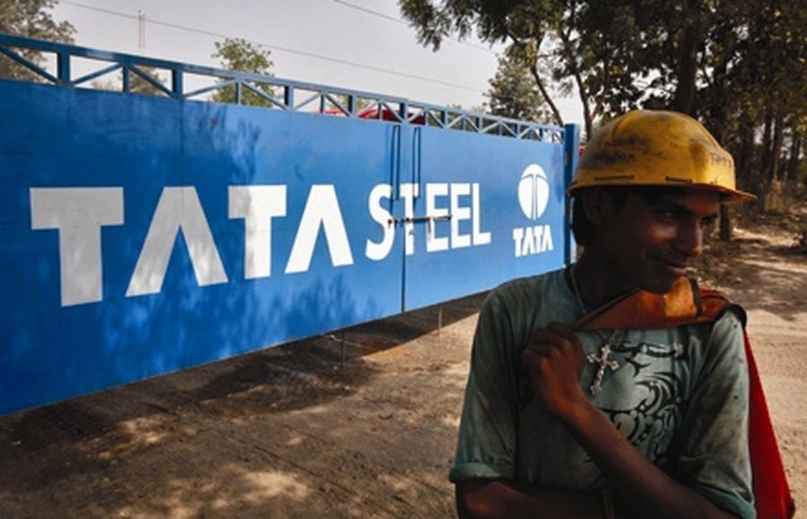 A labourer stands outside a Tata Steel stockyard in the northern Indian city of Chandigarh.