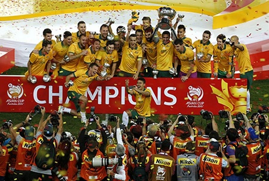 Australia’s players celebrate with the Asian Cup trophy after winning their final soccer match against South Korea at the Stadium Australia in Sydney.