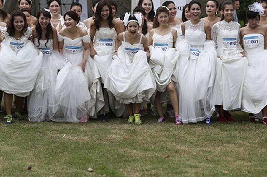 Brides-to-be get ready for the “Running of the Brides” race in a park in Bangkok. 