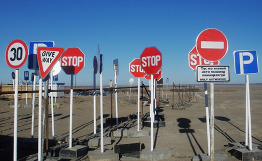 Road signs stand in Mongolia's South Gobi desert awaiting to be deployed during the development of O