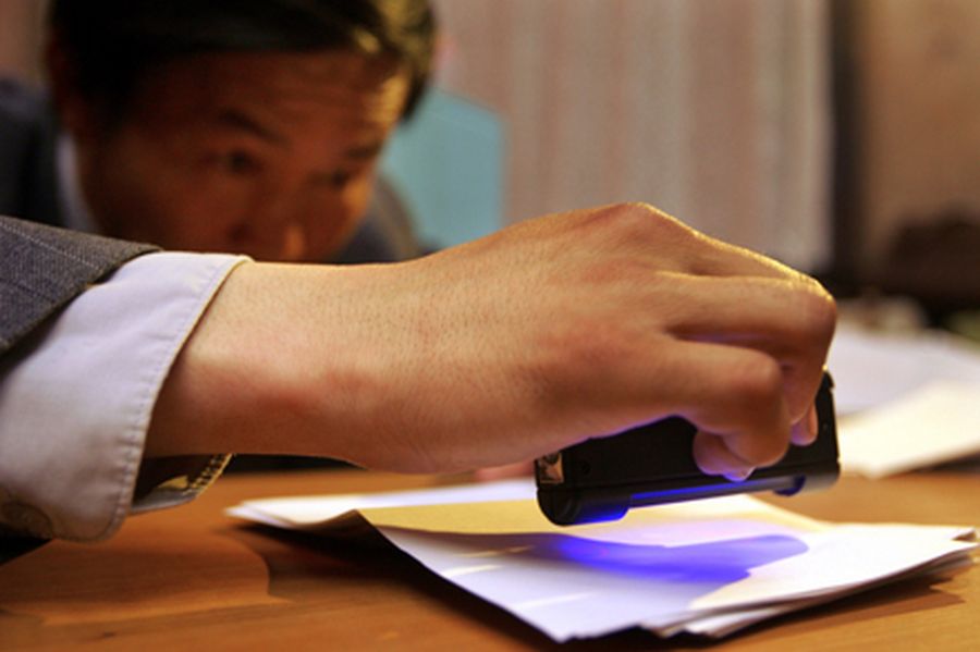 An election worker scans each ballot at a polling station in Ulan Bator. 